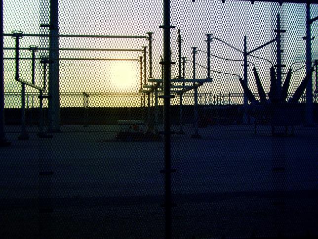 Sun Shining Through Fence